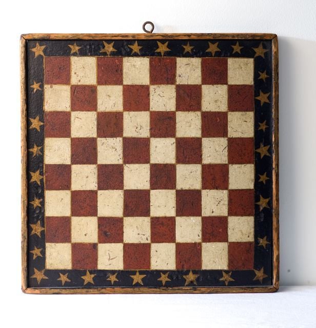 American.

Eight by eight playing fields comprised of
red and white squares divided by gold pin striping.
Surrounded by a blue band and embellished with
gold stars. Entire wood board enclosed in applied
raised frame. Constructed with square
