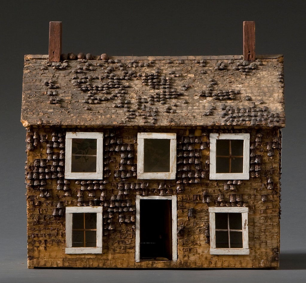 Doll house covered with pinecone siding.
Wall paper interior, glass windows, white window
frames.