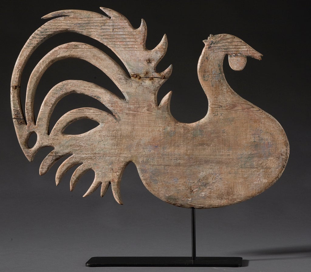 Circa 1880s. 
Oak
Elaborately carved rooster vane with original traces
of polychrome. Some brace repair on one side.  
Purchased at the Los Angeles Antiques Show
at the Ambassador Hotel in 1982-1983.
Attributed to Lombard.
Custom stand
