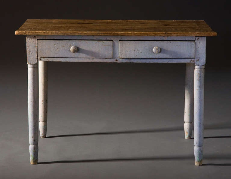 Two drawers with wood pulls. Tapered legs. Gray paint.