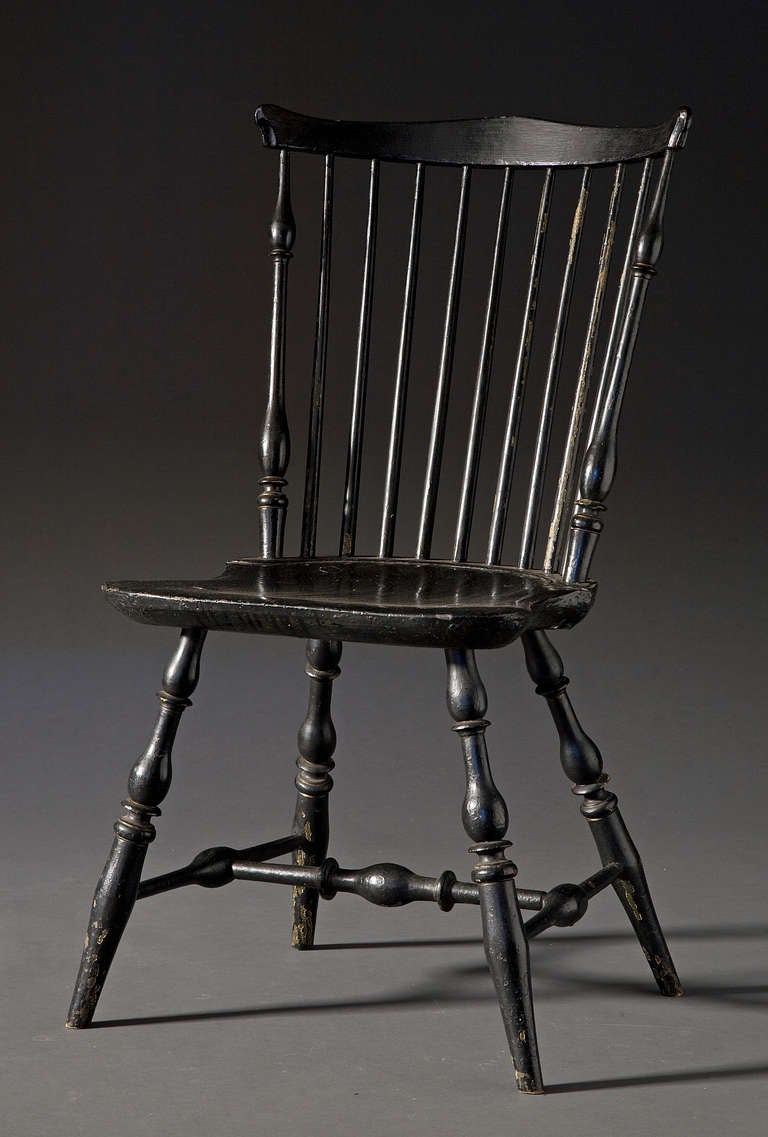 18th Century
Rhode Island
Black paint over traditional green windsor paint.
Ring turned legs with H form stretcher. Saddle seat sits on raised baluster.