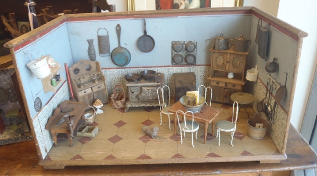 A 19thC German painted and lithographed paper kitchen diorama with an assortment of furnishings