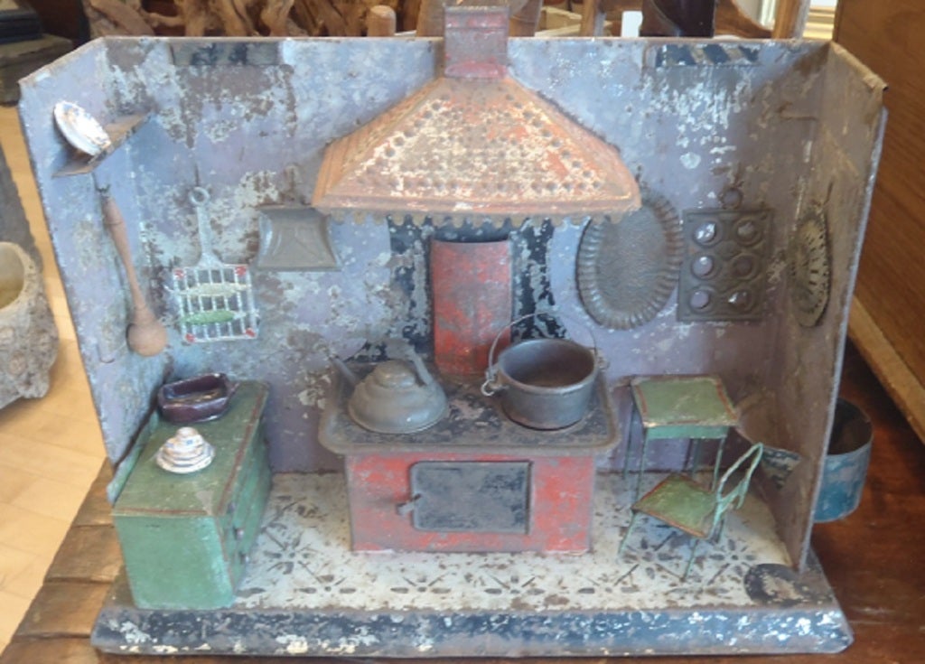 A painted tin diorama/toy French kitchen wth various accessories