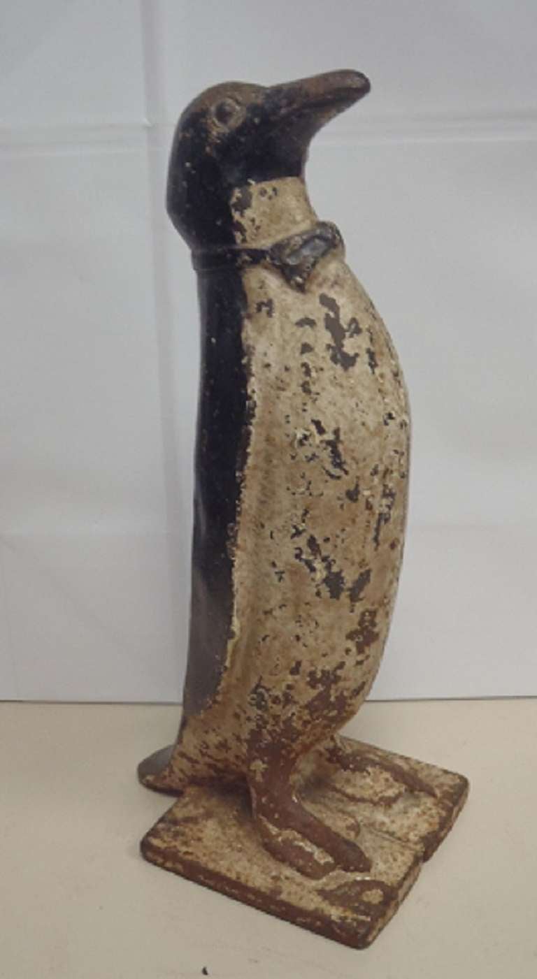 Cast iron door stop in the form of a penguin with bow tie. circa 1920's by Littco Manufacturing, PA.
