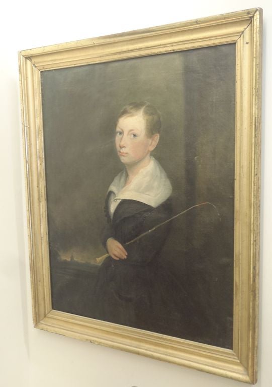 Oil on Canvas of a young rider with riding crop. Gilt wood frame.