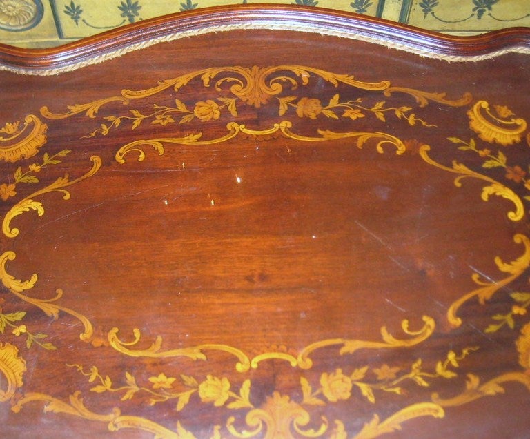 Louis XV style carved mahogany two-tier serving table, having a shaped oval inlaid top with removable glass tray with brass handles, above a shelf with shaped inlaid apron on carved cabriole legs.

After 43 years of business we are retiring.