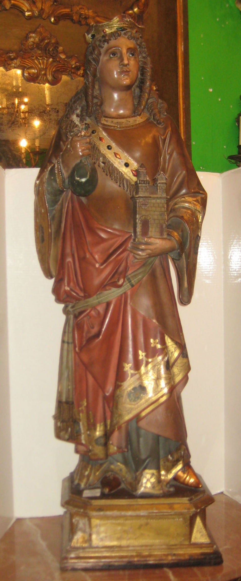 Carved wood and polychrome and parcel gilt figure of Saint Barbara (Santa Barbara) with glass eyes.