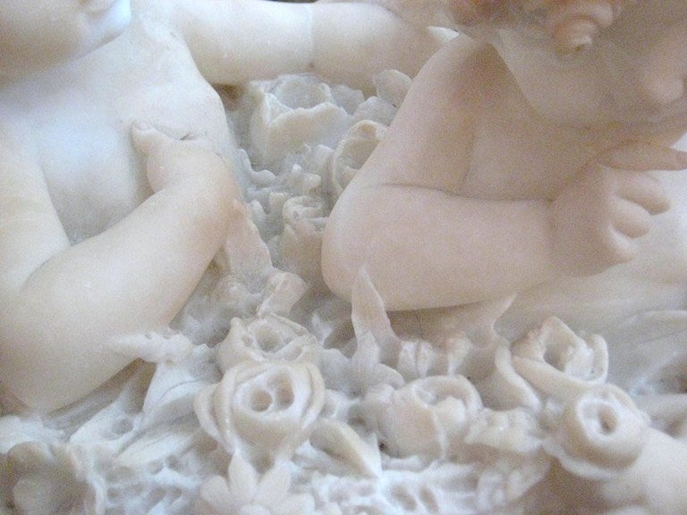 19th Century Continental carved marble group of two Angels seated in a basket of flowers