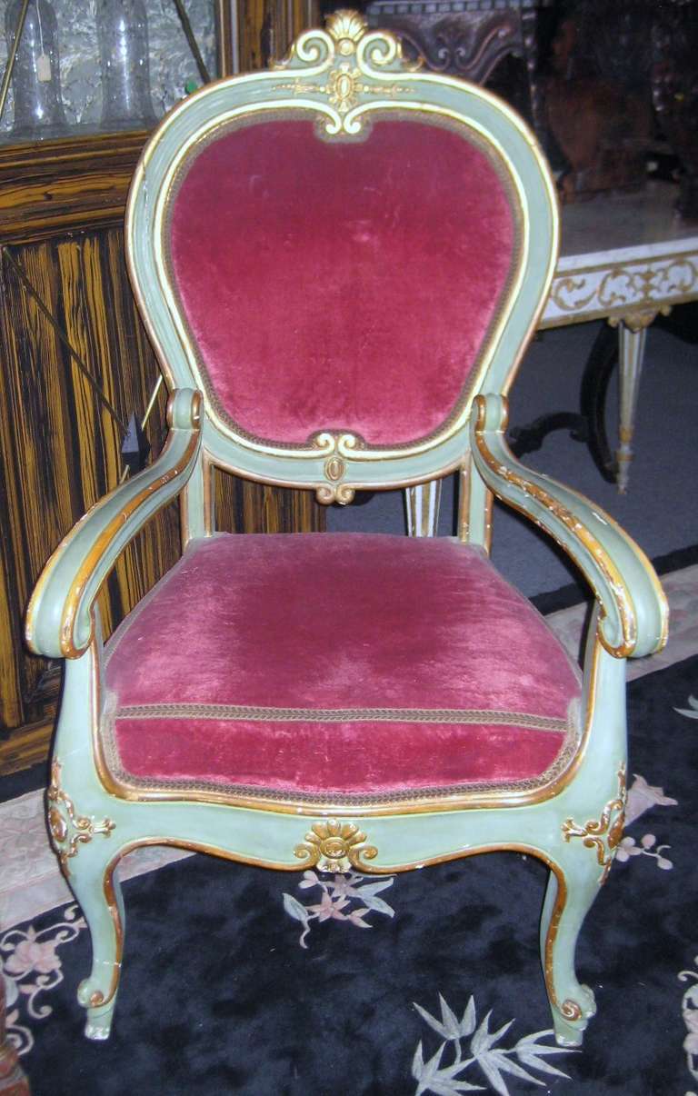 19th c. Venetian green painted and parcel gilt arm chair of generous proportion, having a cartouche shaped back with shell and scroll top rail, scroll molded arms, shaped chair rail joining cabriole legs ending with whorl foot.