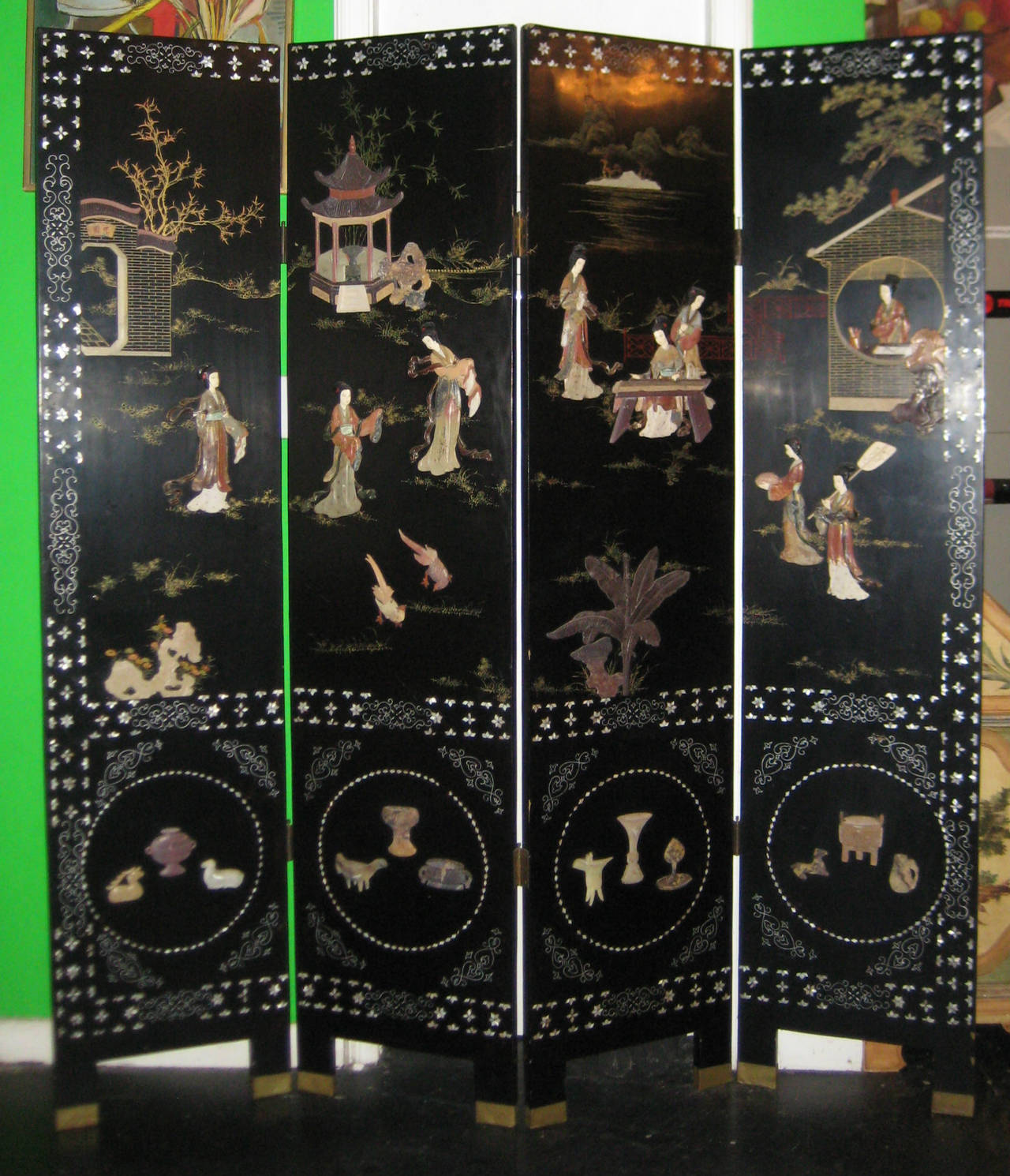 Chinese black lacquer and hardstone mounted four-panel folding screen, the back with engraved and lacquered foliage decoration. H: 72