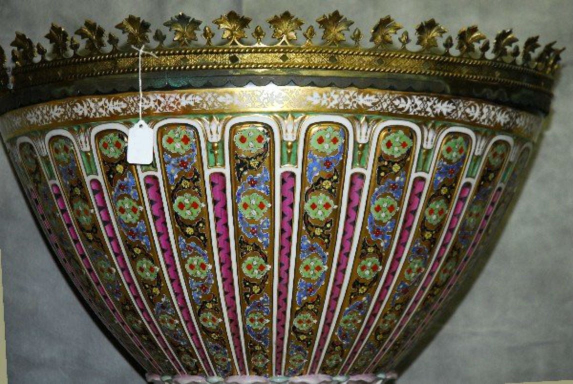 Monumental French bronze-mounted porcelain floral and gilt decorated jardiniere raised on a bronze base with applied masks.