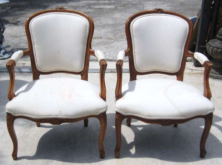 Pair of Louis XV carved walnut fauteuils; the outside back with vertical upright supports, which is indicative of a quality chair and usually only found on 18th century chairs.