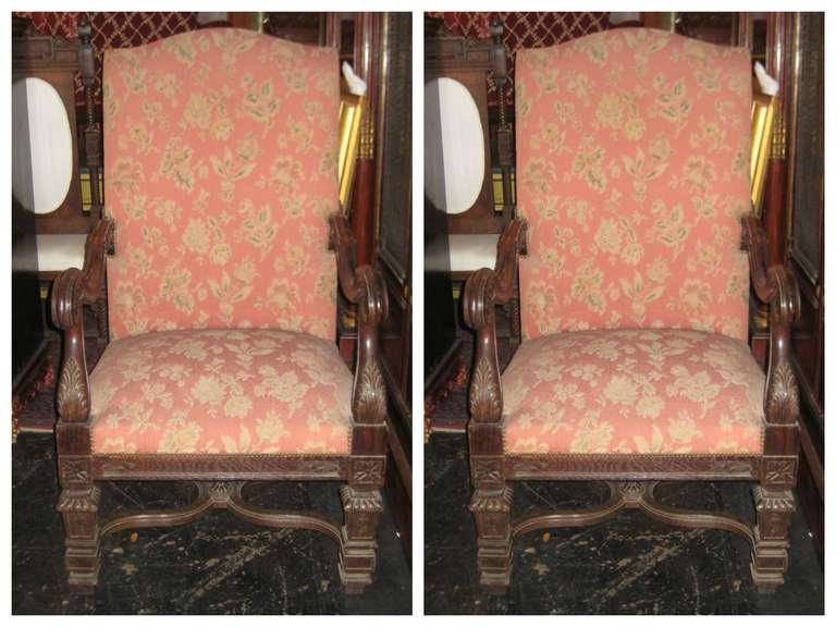 Pair of Italian carved oak open armchairs, having a shaped rectangular back over a rectangular seat, scroll carved arms and chair rail on square carved legs with a molded x-stretcher support.