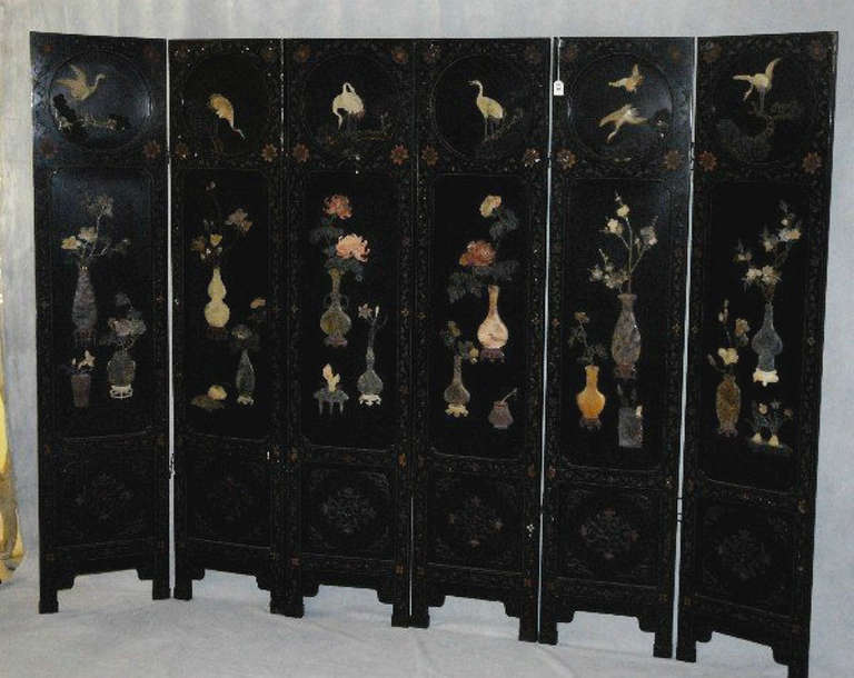 Antique Chinese semi-precious and hardstone mounted black lacquered six-fold Coromandel screen; the reverse decorated with gilt and lacquer foliage.