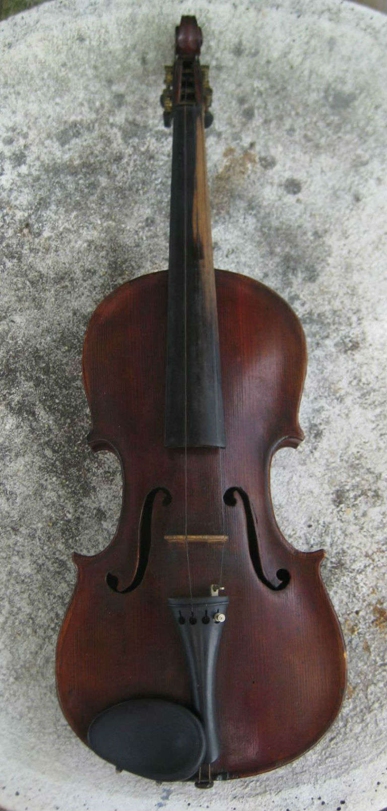 Antique violin, a full size violin with a two-piece maple back of descending horizontal curl, a spruce top and plain ribs, inlaid purfling, the ebony pegs have been replaced with mechainal tuning pegs, corner blocked and lined, bridge with fine