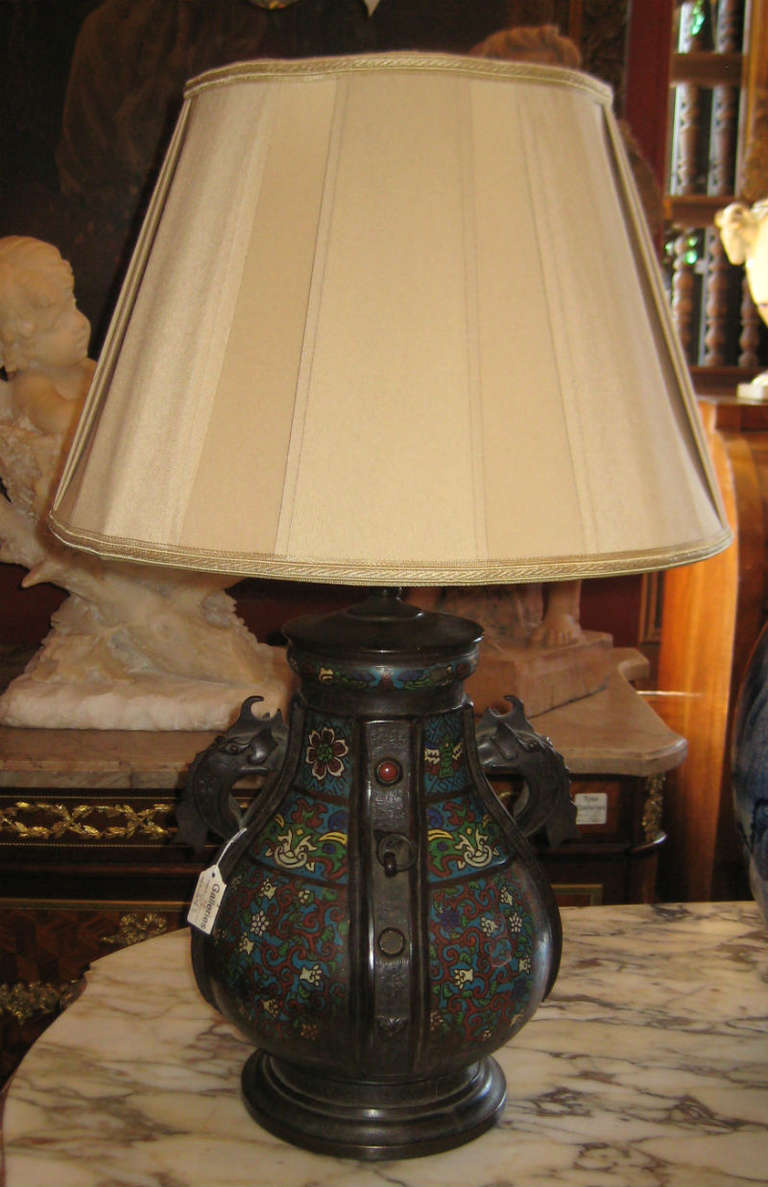 Chinese bronze and cloisonne table lamp with stylized elephant form handles. 

Nice quality US Made vintage shade.

Overall height