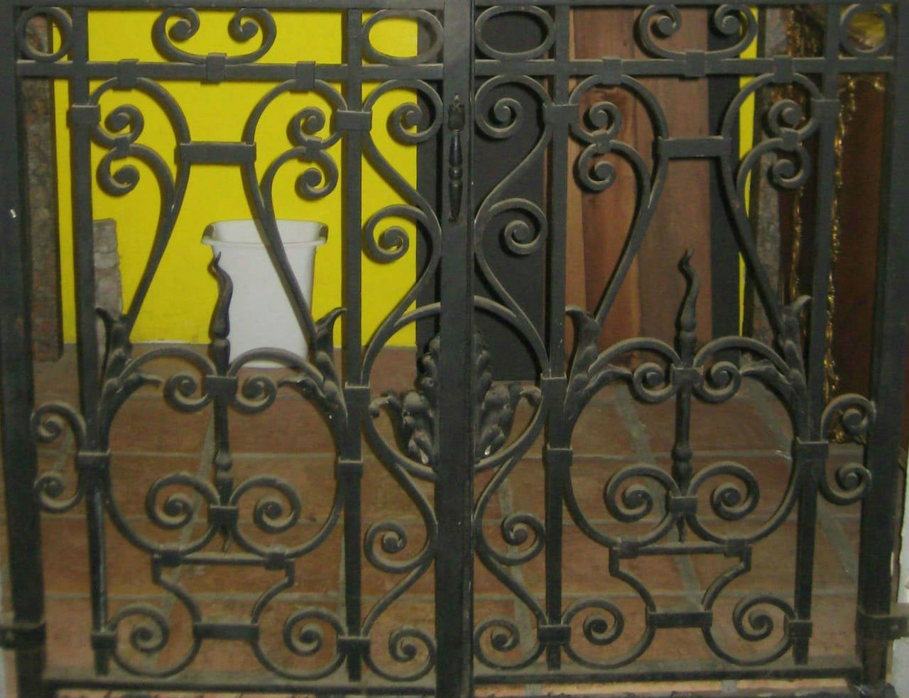 Magnificent antique wrought iron double garden gates with scroll-work and leafage.