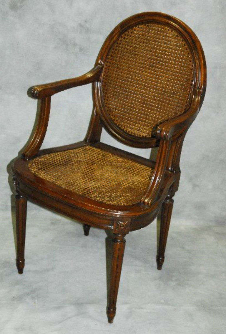 Louis XVI carved mahogany and cane desk chair.