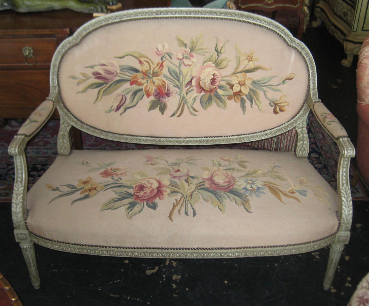 19th century Louis XVI style green painted five-piece salon set with fine needlepoint upholstery. Comprised of four open arm chairs and a settee. Chairs: H: 39.25