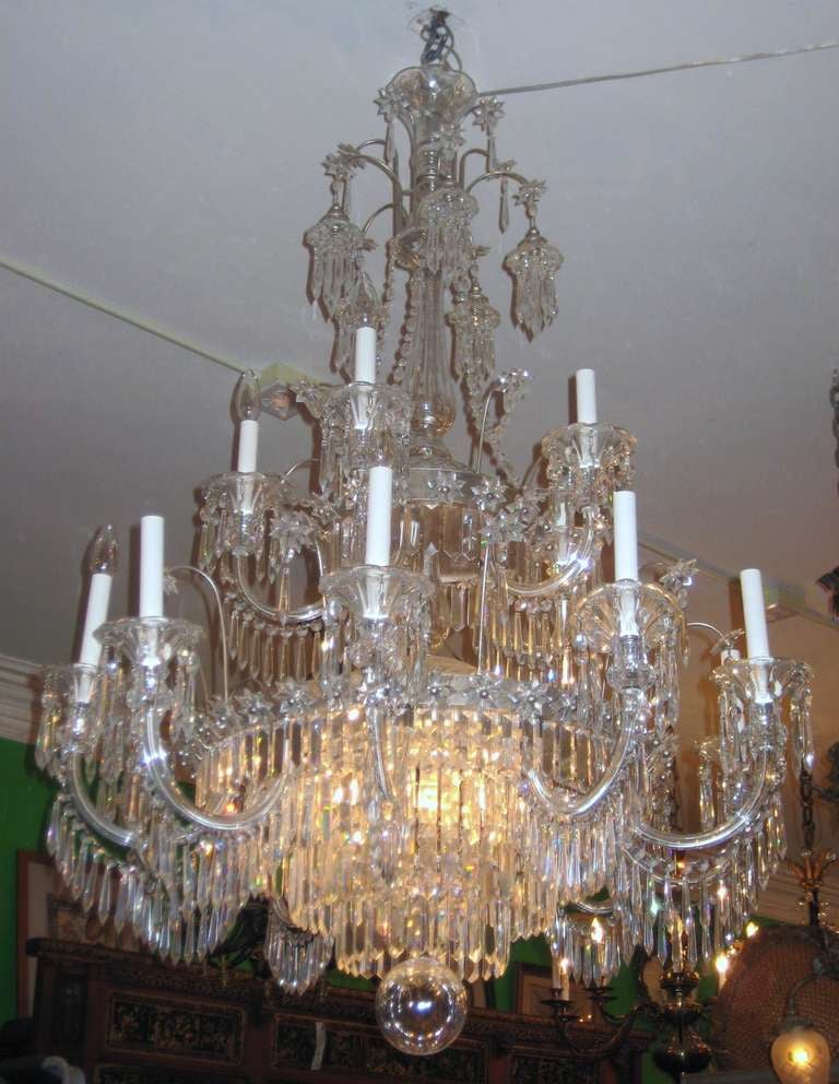 English Regency style fifteen-light crystal chandelier with silvered rings, crystal swag, beads, stars, bobesches and prismatic drops .