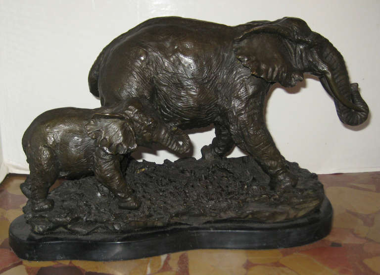 Striding elephants, bronze on a black marble base.