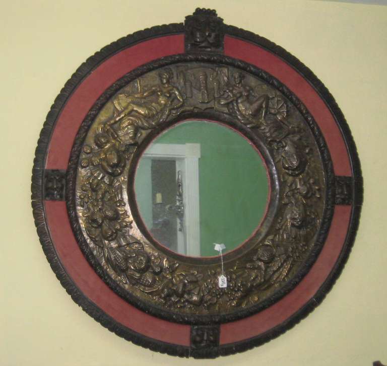 Italian 19th c. Renaissance revival carved oak frame and repoussé brass mirror.