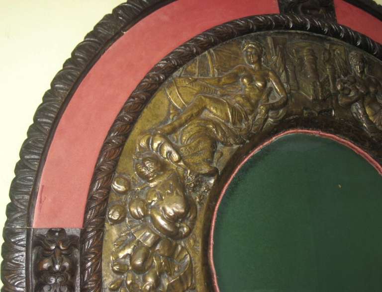 19th Century 19th c. Renaissance revival carved oak frame and repoussé brass mirror.