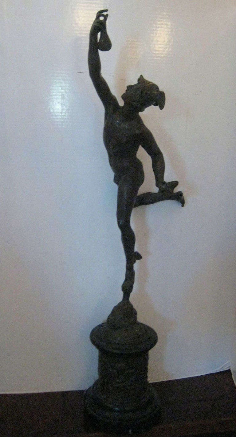 A well cast Bronze figure of Mercury after Giambologna  [Giovanni da Bologna] Italian 1529-1608, on a marble and relief cast bronze socle (columnar base).