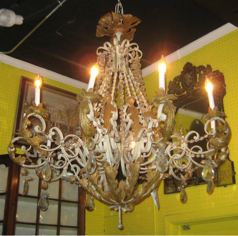 Painted iron and gilt metal and crystal ten-light chandelier.