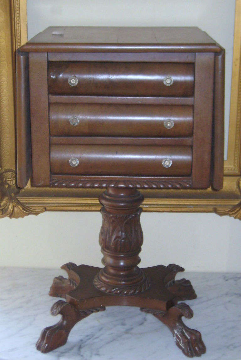 Classical mahogany drop side work table, American, attributed to Anthony Quervelle (1789-1865), circa 1820, having a rectangular top with drop sides above three drawers with original glass pulls on an acanthus leaf carved and turned standard joining