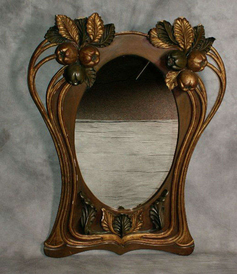 Large Art Nouveau polychrome painted and parcel gilt carved wood mirror with with leaves, fruit and branches.