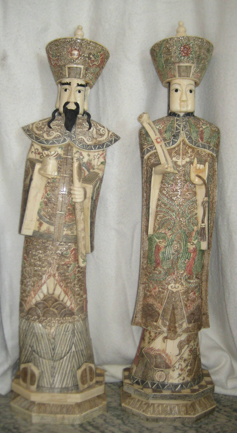 Very large pair of Chinese carved and polychrome bone Emperor and Empress figures; each standing figure is well carved and richly colored on hexagonal bases (width: 12