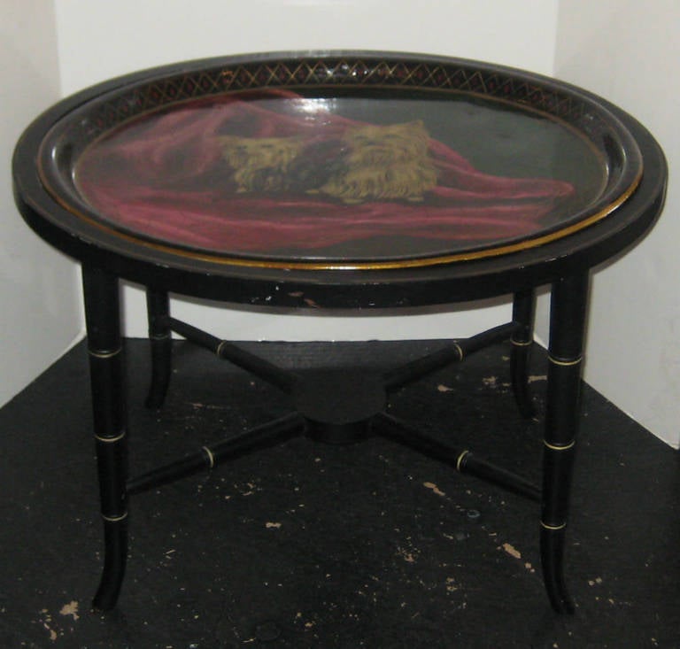 Regency style black lacquer oval faux bamboo tray top table; the tray painted with two Yorkies seated on a red throw. Table height: 17 5/8