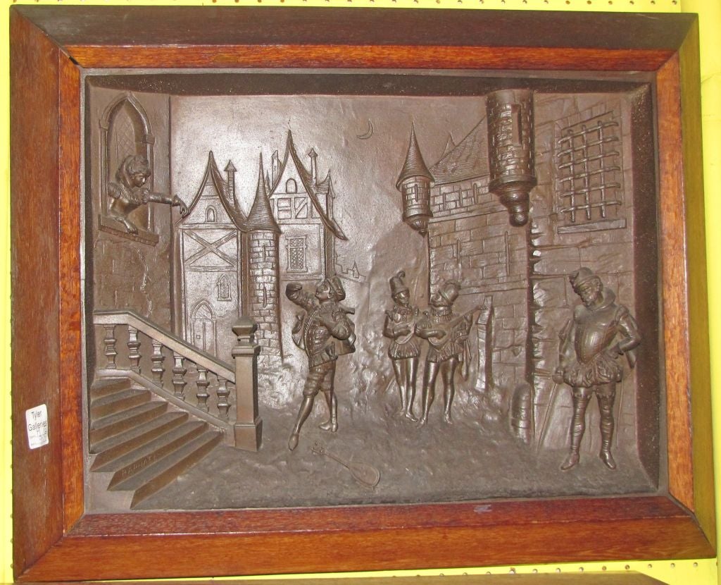 Pair of French iron relief decorated scenic plaques each signed Raphael.