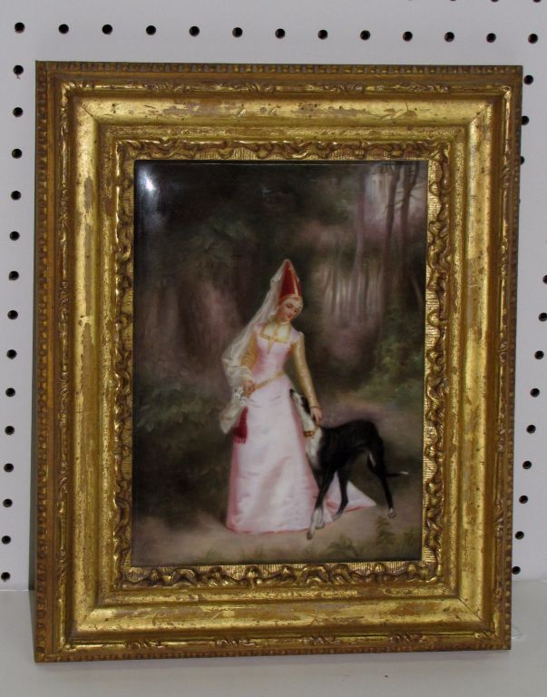Continental painted porcelain plaque depicting a figure with dog in a wooded landscape, signed and dated lower left: Whitridge, 1902 and gilt-wood framed. Sight: 9 3/4