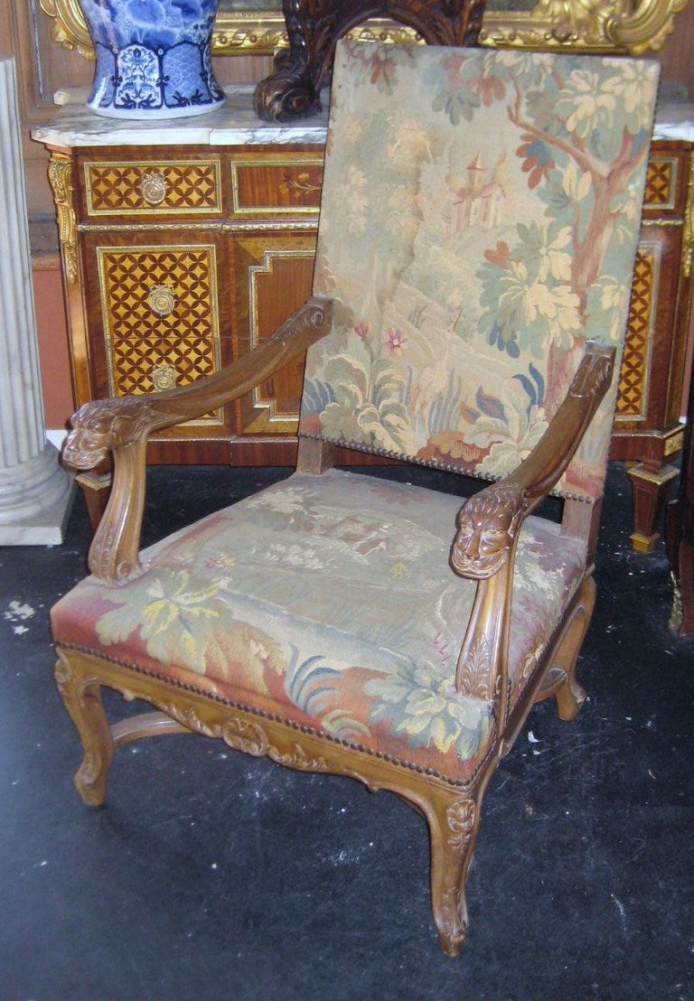 Pair of 19th c. Louis XV style Carved Walnut Fauteuils, each with tapestry upholstery, the arms terminating with lion masks, carved seat rails on cabriole legs with x-form stretcher supports.

After 43 years of business we are retiring. Everything