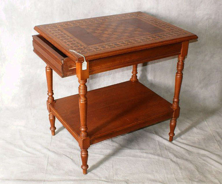 Italian inlaid game table, the rectangular inlaid chess/checker board top above a single frieze drawer on block and turned tapering legs joining a stretcher shelf. H: 30.5