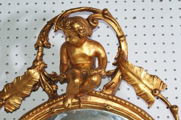 19th century Continental carved wood and gilt gesso figural girandole mirror