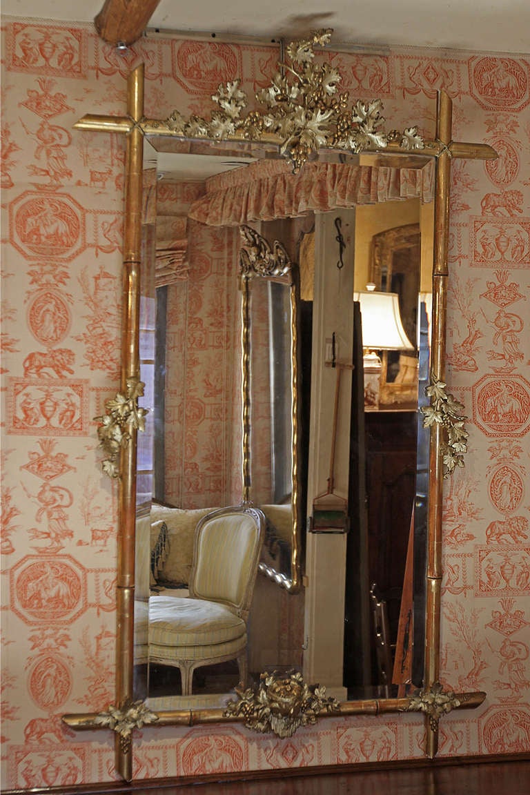 19th Century French Bamboo Design Wooded Gilded Mirror With Beveled Glass, Carved Grapes And A Nest With Two Baby Birds
H 61¼