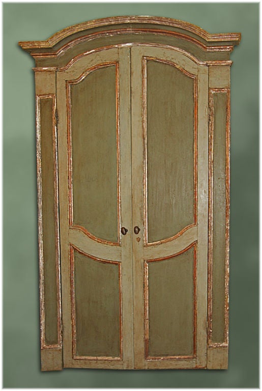 Beautiful 18th century Regence hand-carved, hand-painted and silver leafed wooden Italian double doors in frame with gendarme style (curved) cornish with iron door knob, lock and key. These are from the Piedmont region of Italy, circa 1715.