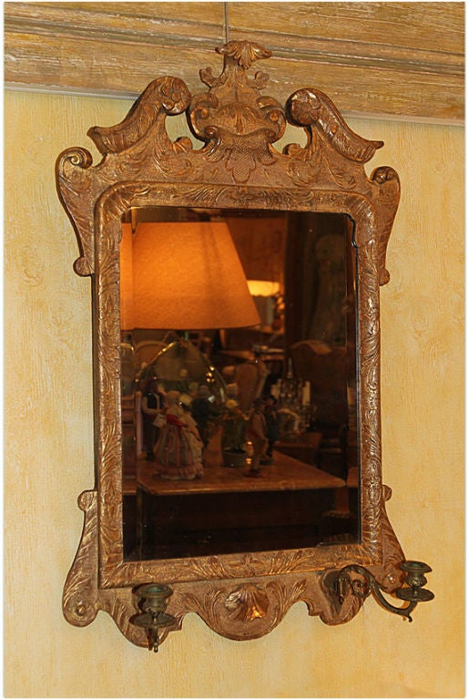 18th century English hand-carved giltwood and gesso mirror (beveled) with sconces, circa 1730-1760.
Measures: H 38½", W 24".