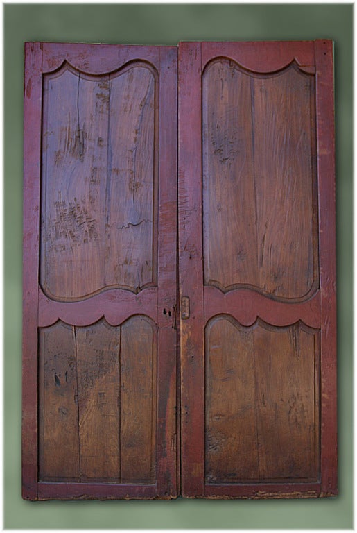 PAIR OF 19TH CENTURY HAND-CARVED FRENCH CHERRY DOORS WITH WOODEN PEGS.  FROM THE PICARDI REGION, CIRCA 1860
H 62½