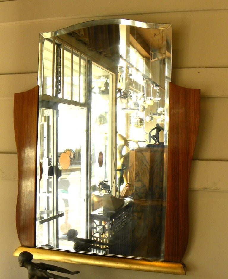 
A beautiful and striking Art Deco Mirror frame with new beveled glass mirror. The style is Art Deco, circa 1940s and would look great over a buffet, crowning a hallway or just about anywhere you might need to see who is the fairest of them all!