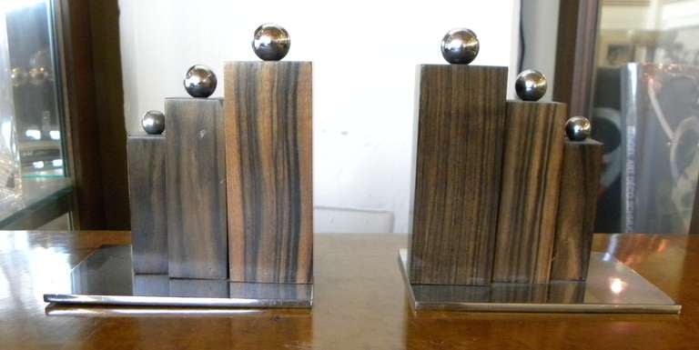 Nice original French Art Deco Modernist bookends. Three stepped wood columns all crowned with chrome balls set off this stunning design. Chrome base to pull it all together. All original circa 1930′s.

Measurements:
4.5″ T x 4.75″ D x 3″ W