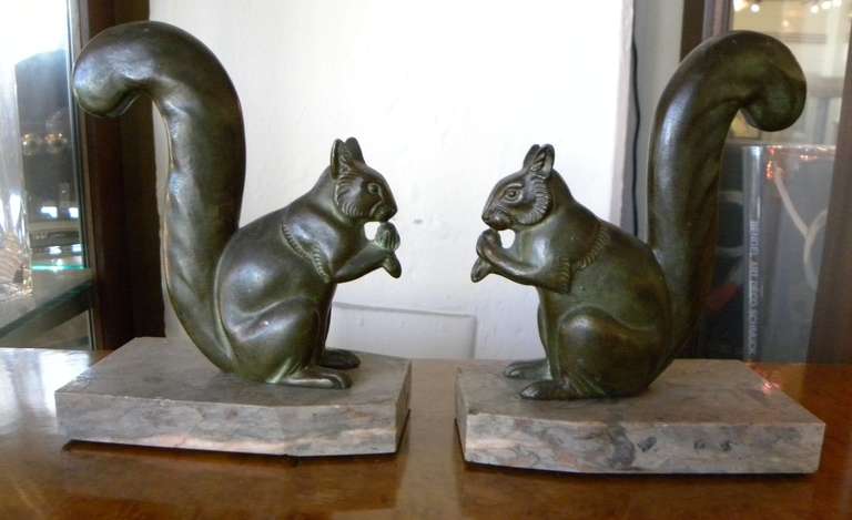 Just like mother nature intended. These little squirrels are munching away on a little acorn. Both with the big bushy tails you expect to see, both on nice marble bases. Signed on the statue Ledule, Metal and original French Style circa