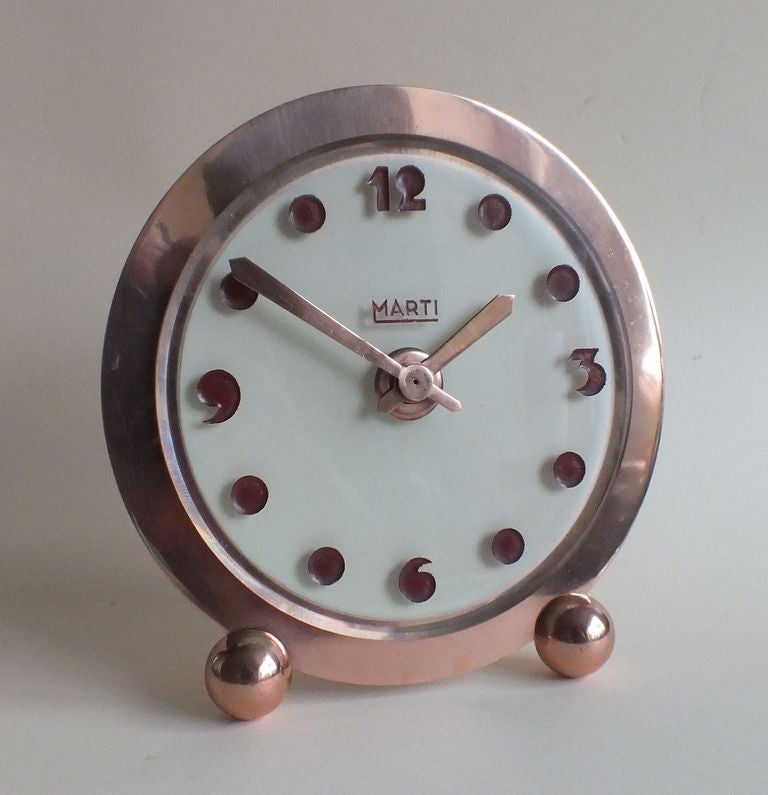 Stunning Art Deco Clock with all metal parts being copper plated bronze and all in excellent original condition. Unusual thick glass dial with very stylized acid etched numerals and dot markers with lovely copper plated sword Hands indicating the