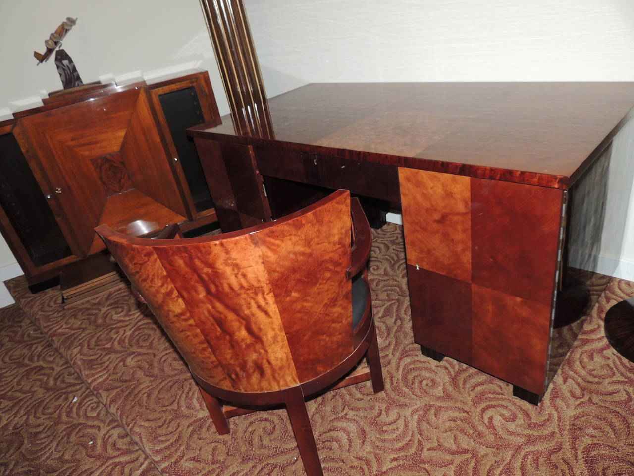 Spectacular four-piece Art Deco mahogany desk suite in beautiful condition. Sleek, elegant, important and powerful, these four matched pieces will instantly transform your office decor. The desk makes inventive use of checkerboard veneer showcasing