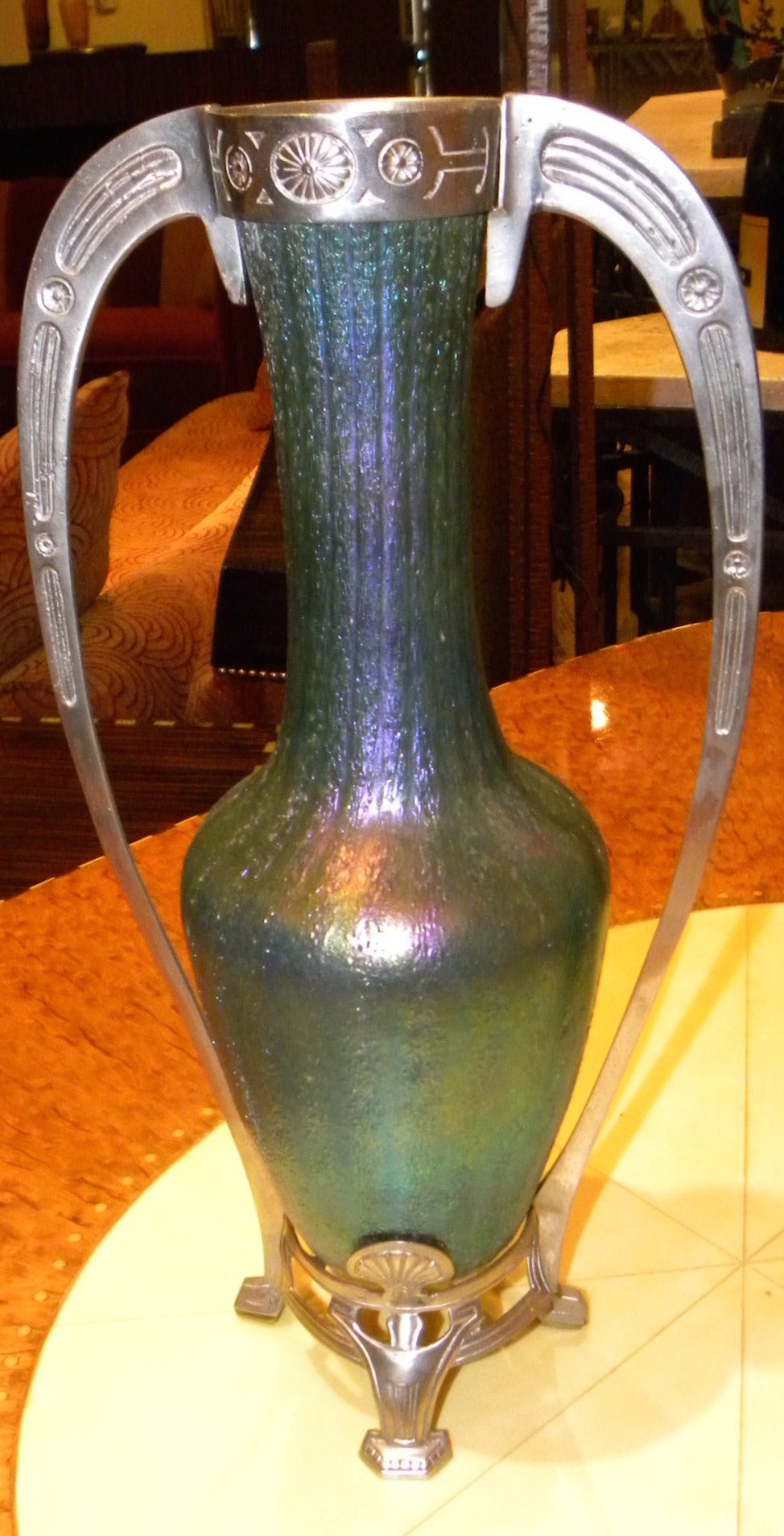 Pair of Art Nouveau green glass Loetz style vases with decorative metalwork mountings and handles that are a beautiful example of the iridescent, opalescent and elegant pieces made between 1905 and 1920. It is rare to locate a matching pair of