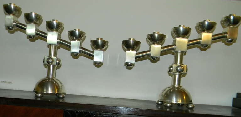 A stunning and dynamic pair of Art Deco candlesticks. The most modernist shape you could imagine and yet still be very simple and elegant. The angular shape allows for a special arrangement, either on a your table, buffet or mantel. Each candlestick