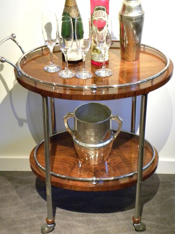 Stunning and elegant! Circa 1930's  and wonderful wood (book matched and two levels), nice metal, nice wheels all original and ready to put into your home. This lovely little bar cart (or tea or desert cart) can augment any hospitality you are